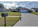 Front view of house with driveway and mailbox at 6932 Oakcrest Way, Zephyrhills, FL 33542