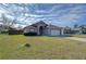 One-story house with attached garage and front yard at 6932 Oakcrest Way, Zephyrhills, FL 33542