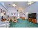 Spacious living room featuring two ceiling fans and ample natural light at 6932 Oakcrest Way, Zephyrhills, FL 33542