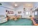 Living room featuring vaulted ceiling, green carpet and a seating area at 6932 Oakcrest Way, Zephyrhills, FL 33542