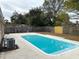 Relaxing pool area with a spacious deck and fenced backyard at 6985 82Nd N Ave, Pinellas Park, FL 33781