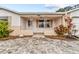 Inviting home exterior with a brick facade and landscaped walkway at 7051 Nova Scotia Dr, Port Richey, FL 34668