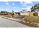 Single story home with a brick facade and paved driveway at 7051 Nova Scotia Dr, Port Richey, FL 34668