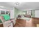 Living room with hardwood floors, green walls, and view of kitchen at 7051 Nova Scotia Dr, Port Richey, FL 34668