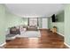 Living room with hardwood floors and light green walls at 7051 Nova Scotia Dr, Port Richey, FL 34668