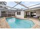 Sparkling pool with screened enclosure and patio at 7051 Nova Scotia Dr, Port Richey, FL 34668