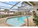 Refreshing kidney-shaped pool with covered patio at 7051 Nova Scotia Dr, Port Richey, FL 34668