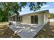 Spacious backyard patio with screened enclosure and lush landscaping at 7304 Gates Cir, Spring Hill, FL 34606