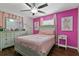 Pink bedroom with a double bed, dresser, and window at 7304 Gates Cir, Spring Hill, FL 34606