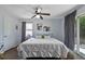 Main bedroom with a ceiling fan, lots of natural light and hardwood floors at 7304 Gates Cir, Spring Hill, FL 34606