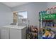 Laundry room with washer, dryer, and storage shelves at 7304 Gates Cir, Spring Hill, FL 34606