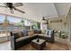 Relaxing screened porch with wicker furniture and ceiling fan at 7304 Gates Cir, Spring Hill, FL 34606