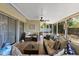 Relaxing screened porch with comfortable seating and ceiling fan at 7304 Gates Cir, Spring Hill, FL 34606