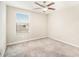 Well-lit bedroom with ceiling fan and carpet at 7610 Blue Iris Ln, Tampa, FL 33619