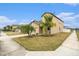 Two-story house with tan exterior, landscaping, and driveway at 7610 Blue Iris Ln, Tampa, FL 33619