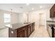 Eat-in kitchen with island, granite countertops, and ample cabinet space at 7610 Blue Iris Ln, Tampa, FL 33619