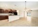 Open concept kitchen with island and dark brown cabinets at 7610 Blue Iris Ln, Tampa, FL 33619