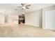 Spacious living room with tile floor and kitchen access at 7610 Blue Iris Ln, Tampa, FL 33619