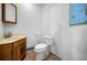 Small bathroom with wood vanity and corner toilet at 8001 70Th N St, Pinellas Park, FL 33781