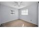 Simple bedroom with carpet flooring and ceiling fan at 8001 70Th N St, Pinellas Park, FL 33781