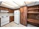 White appliances and wood cabinets in this kitchen at 8001 70Th N St, Pinellas Park, FL 33781