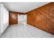 Living room with wood paneling and tile flooring at 8001 70Th N St, Pinellas Park, FL 33781