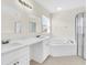 Elegant bathroom with double vanity, soaking tub, and shower at 8243 47Th Street E Cir, Palmetto, FL 34221