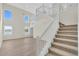 Two-story foyer with a staircase and wood flooring at 8243 47Th Street E Cir, Palmetto, FL 34221