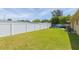 Large backyard with grassy lawn and white fence at 8310 Archwood Cir, Tampa, FL 33615