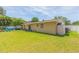 Large backyard with grassy lawn and white fence at 8310 Archwood Cir, Tampa, FL 33615