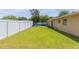 Large backyard with grassy lawn and white fence at 8310 Archwood Cir, Tampa, FL 33615