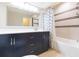 Modern bathroom with dark vanity and shower at 8310 Archwood Cir, Tampa, FL 33615