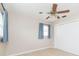 Bedroom with ceiling fan, light blue curtains, and closet at 8310 Archwood Cir, Tampa, FL 33615