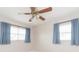 Bedroom featuring light blue curtains and ceiling fan at 8310 Archwood Cir, Tampa, FL 33615