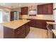 Updated kitchen with dark wood cabinets and an island at 8310 Archwood Cir, Tampa, FL 33615