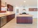 Modern kitchen with stainless steel appliances and an island at 8310 Archwood Cir, Tampa, FL 33615