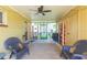 Spacious screened porch with seating and storage shelves at 8310 Archwood Cir, Tampa, FL 33615