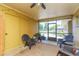 Relaxing screened porch with seating and ceiling fan at 8310 Archwood Cir, Tampa, FL 33615