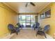 Relaxing screened porch with seating and ceiling fan at 8310 Archwood Cir, Tampa, FL 33615