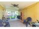 Spacious screened porch with seating and storage shelves at 8310 Archwood Cir, Tampa, FL 33615