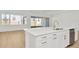 Modern kitchen island with white cabinets and gold faucet at 8421 Golden Beach Ct, Parrish, FL 34219