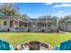 Large backyard with firepit and screened patio at 8460 Parkwood Blvd, Seminole, FL 33777