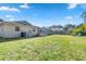 Large grassy backyard with screened patio at 8460 Parkwood Blvd, Seminole, FL 33777