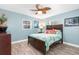 Bright bedroom with a comfortable bed and hardwood floors at 8460 Parkwood Blvd, Seminole, FL 33777