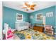 bedroom with crib, toys, and cheerful decor at 8460 Parkwood Blvd, Seminole, FL 33777