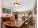 Charming dining area with wood table and chairs, adjacent to the living room at 8460 Parkwood Blvd, Seminole, FL 33777