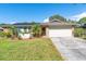 Ranch-style home with solar panels, landscaped yard, and attached garage at 8460 Parkwood Blvd, Seminole, FL 33777