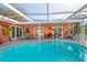 Inviting kidney-shaped pool with covered patio and lounge area at 8460 Parkwood Blvd, Seminole, FL 33777