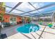 Inviting kidney-shaped pool with covered patio and lounge area at 8460 Parkwood Blvd, Seminole, FL 33777