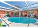 Inviting kidney-shaped pool with covered patio and lounge area at 8460 Parkwood Blvd, Seminole, FL 33777